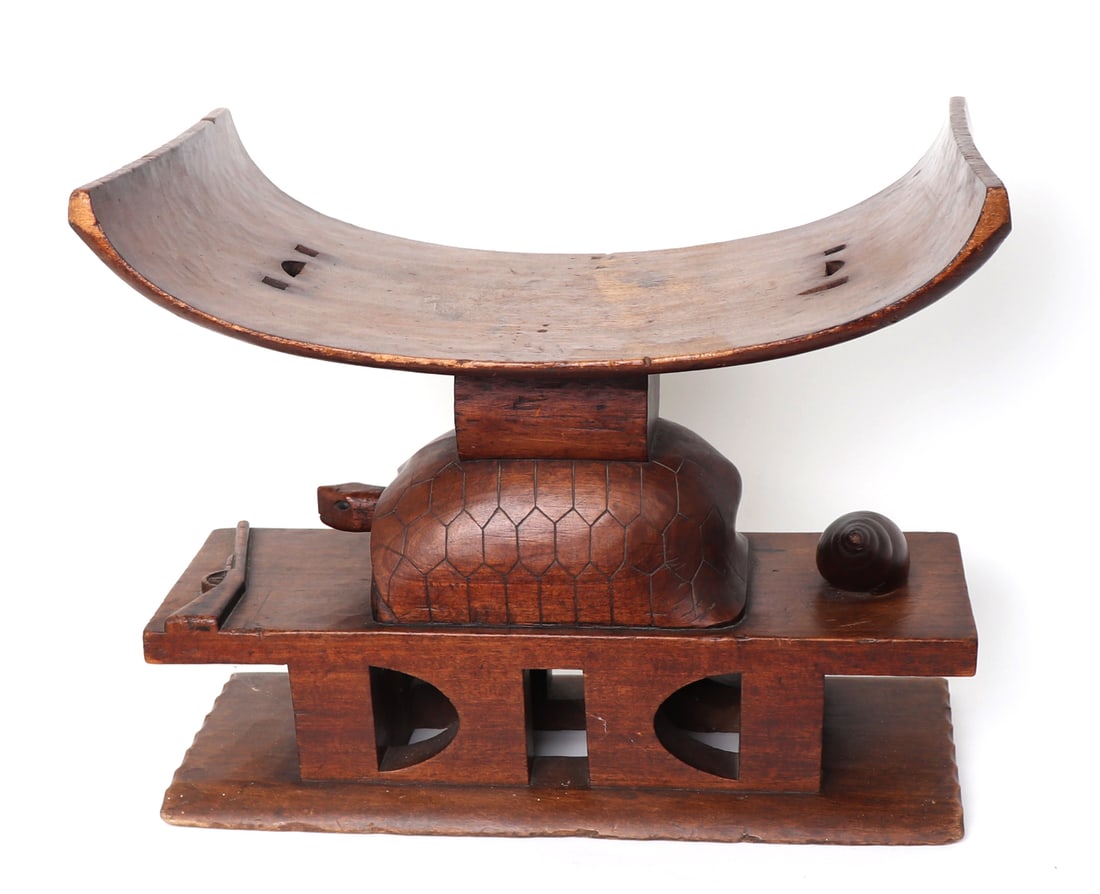 Ashanti Proverbs Stool, West Africa: West Africa, Ghana, Ashanti peoples wood carved stool or throne chair. Distinct U-shaped top with three pierced holes. Carried on the back of a carved tortoise with a rifle forward and large snail in