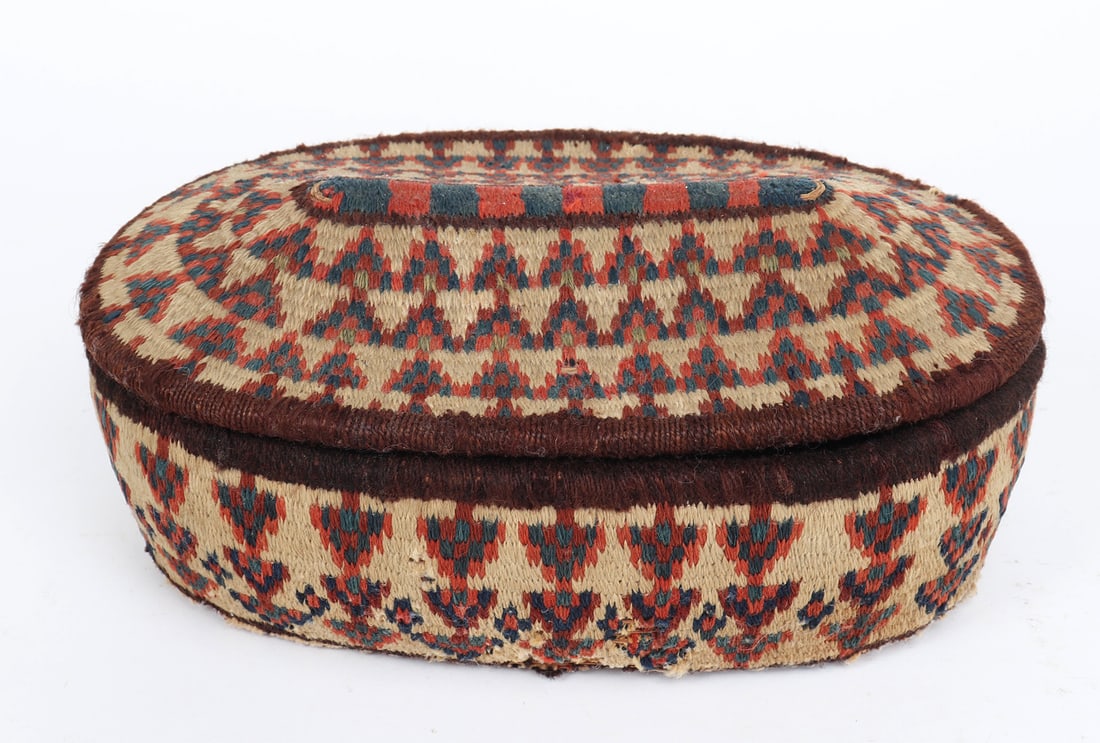 Southwest Persian Egg Basket: Hand woven south Persian basket with triangular and arrowhead like designs in bright blue and red coloring against a cream background with brown edges. Size 4" H x 11 3/4" W