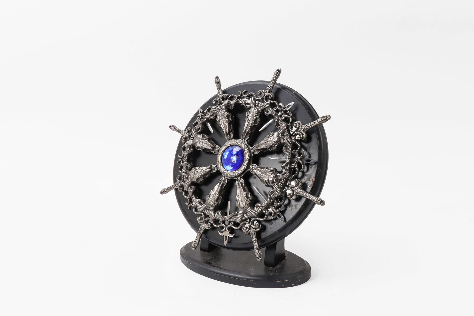 Spinning Miniature Sword Holder: Unusual decorative metal spinning miniature sword holder with center gem possibly for cocktail serving. 11.5 by 11.5 "