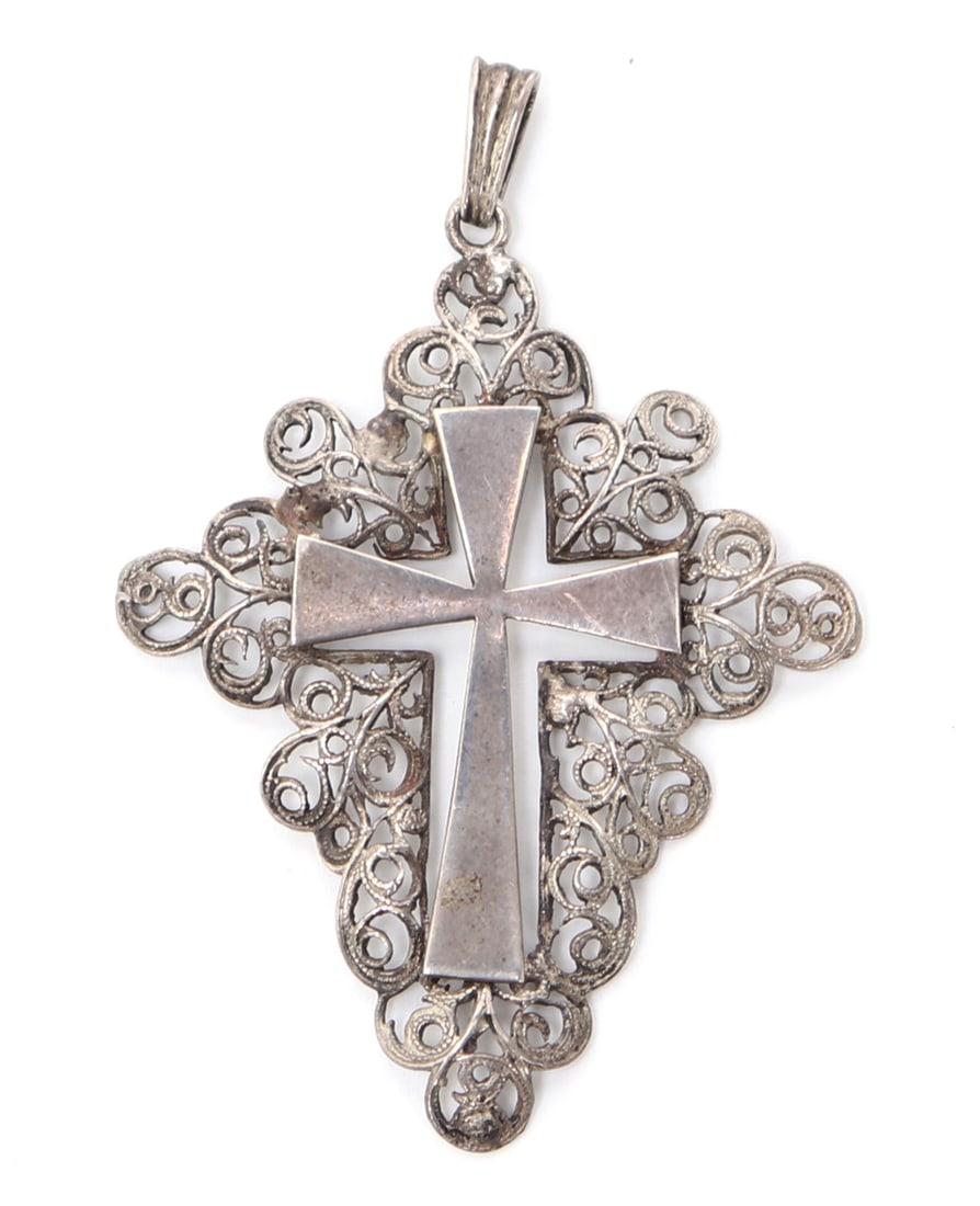 Sterling Silver Openwork Cross Pendant, 4g: Nicely pierced openwork cross pendant in sterling silver. Background in a fine openwork of scrolling motifs with the cross held at either corner through loops. Size 2" H x 1 1/2" W, 4 gramsEx-USA