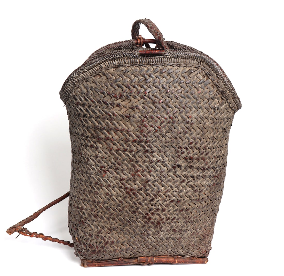 Large Philippines Bamboo and Rattan Backpack: Beautiful rattan and bamboo backpack with a large pouch. Backpacks like these were likely used in harvesting grains, nuts or fruits. The distinct variation in color indicates it was well worn and