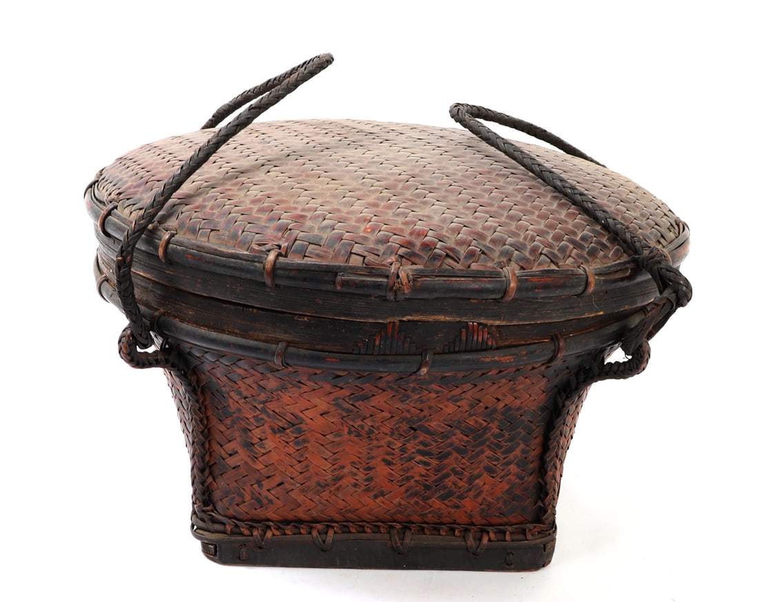 Antique Ifugao Rattan Woven Basket with Lid: Wonderful handmade antique basket from the Philippines. Two braided handles with reinforced wood and bamboo base. Braided rattan body with braided and reinforced rattan lid. Size 16 1/4" W
