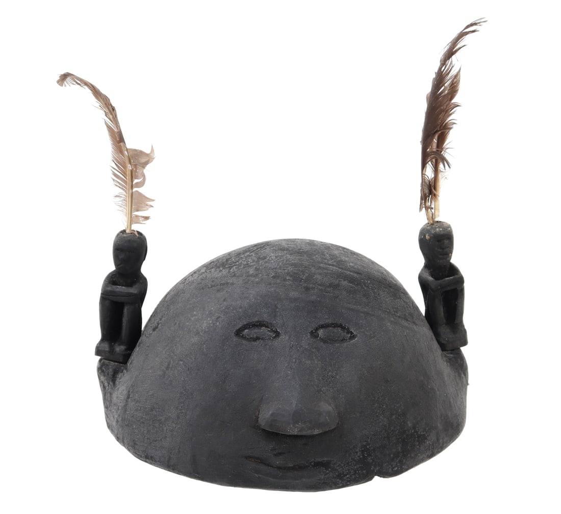 Filipino Wood Carved Bulul Helmet: Finely carved Bulul helmet from the Philippines. Carved from a single piece of light wood, featuring a human like face to the front with almond slit eyes, slight protruding triangular nose and slit mo