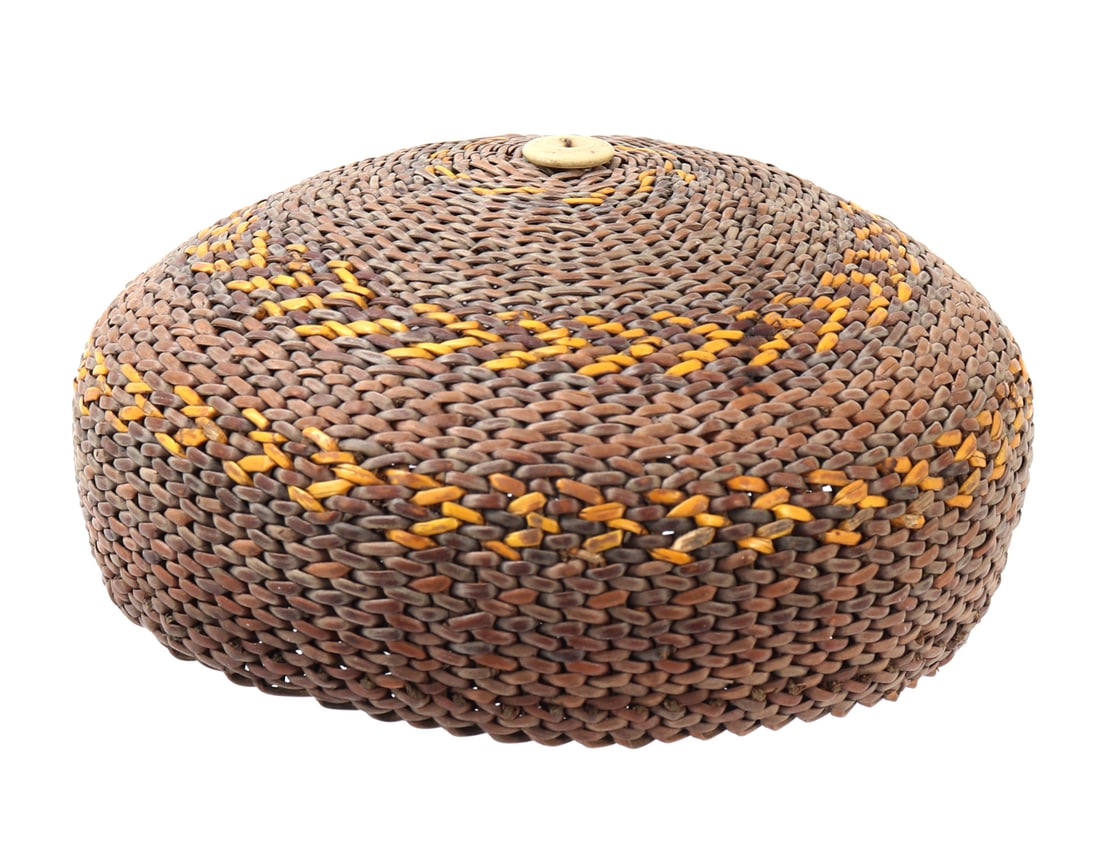 Handmade Rattan Sleeping Hat, Philippines: Wonderfully well crafted hat from the Philippines, comprised of rattan in light brown and tan coloring with a lovely yellow pigment. Bone button to the top. Size 5 1/2" W, 2 1/2" H