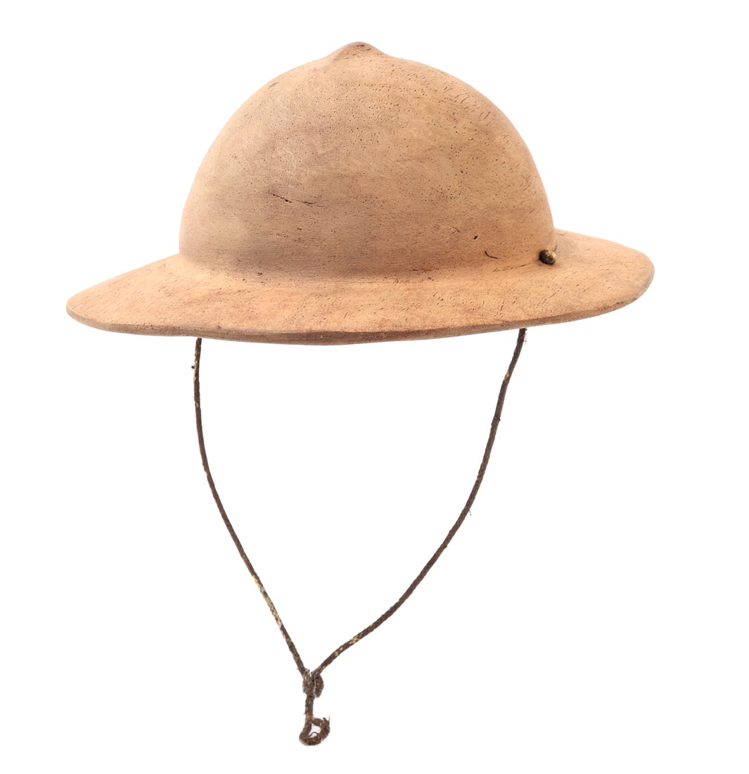 Filipino Pith Style Helmet: Wood carved Filipino pith style helmet with braided cord strap. Light blonde colored wood with a slight pointed finial to the top. Size brim 12 1/8" L, ID 7" L x 6 1/4" W