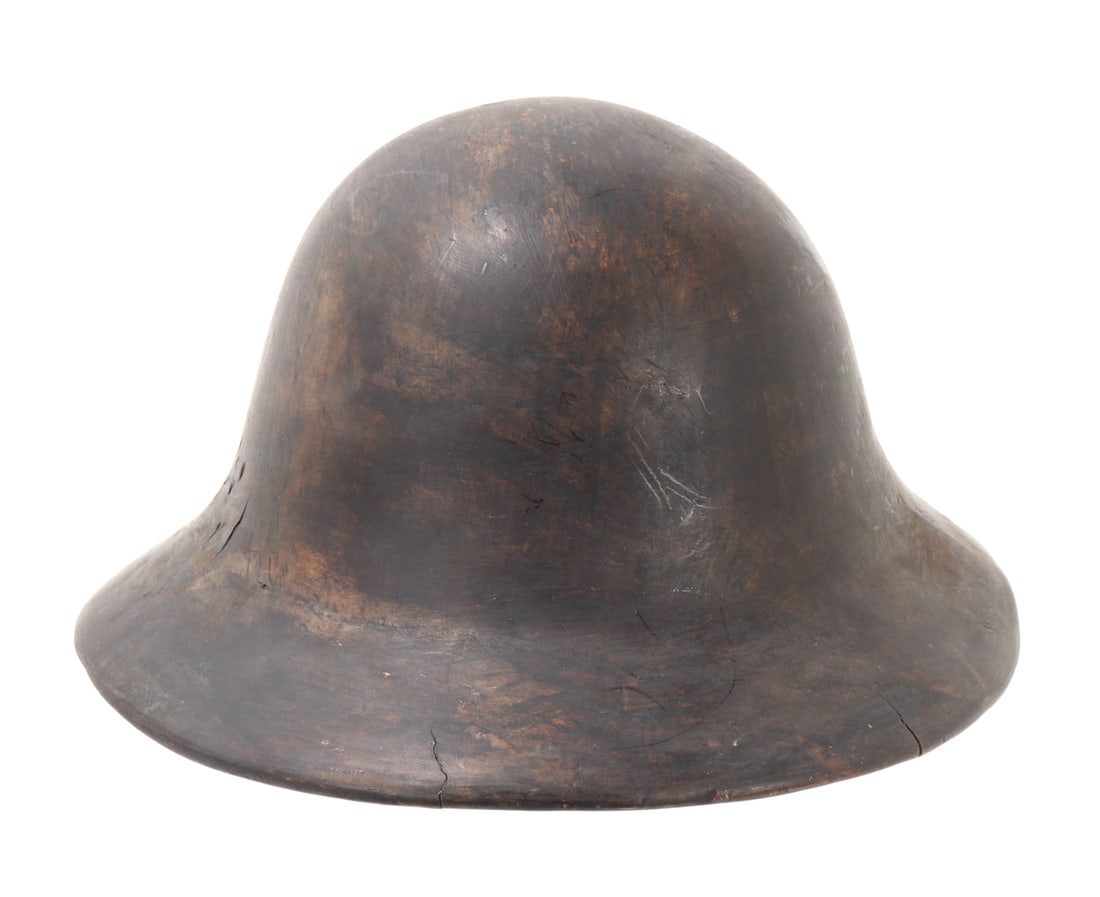 Filipino Wood Carved Helmet: Finely crafted wood carved helmet from the Philippines. Carved from a single piece of wood with a dark brown patina from age and use. Size 10 3/8" L, ID 7 1/2" L x 6 1/2" W, 4 1/2" H