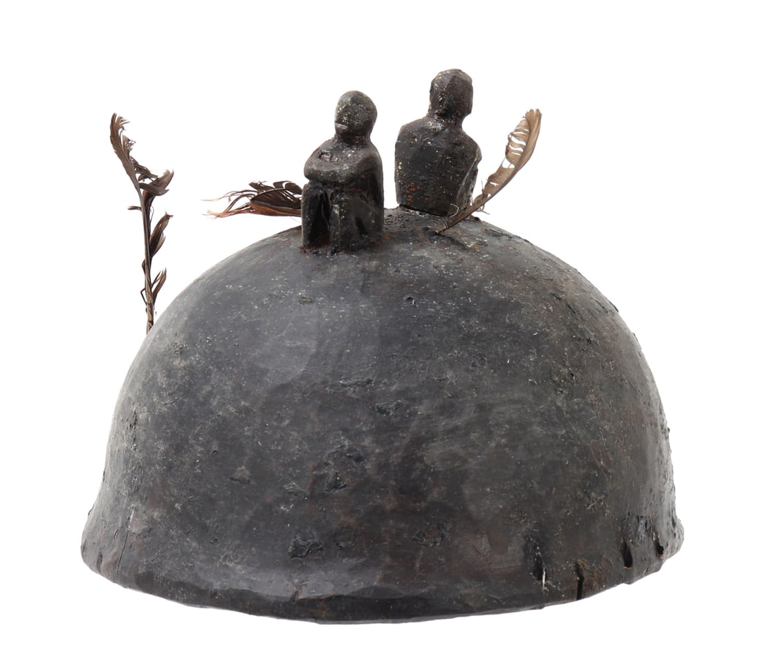 Filipino Wood Bulul Helmet: Nicely carved wood helmet from the Philippines. Topped with a pair of seated Bulul figures, carefully pierced to the sides in order to adorn the helmet with feathers. Likely worn ceremonially and not