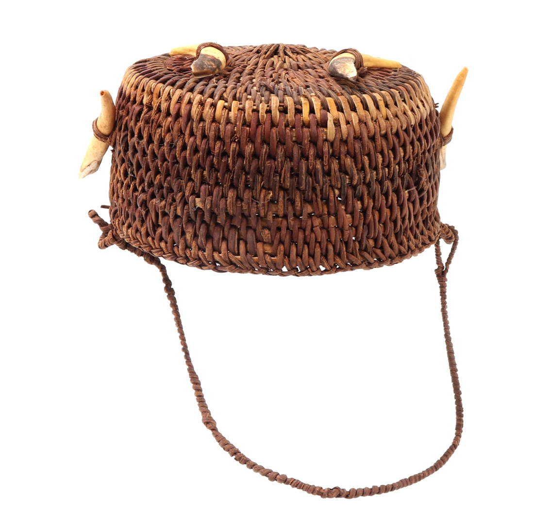 Filipino Rattan & Tusk Young Adult Hat: Finely crafted rattan woven hat from the Philippines adorned all over with boar tusks. Braided rattan strap for wearing. Size 5" W, 2 3/8" H