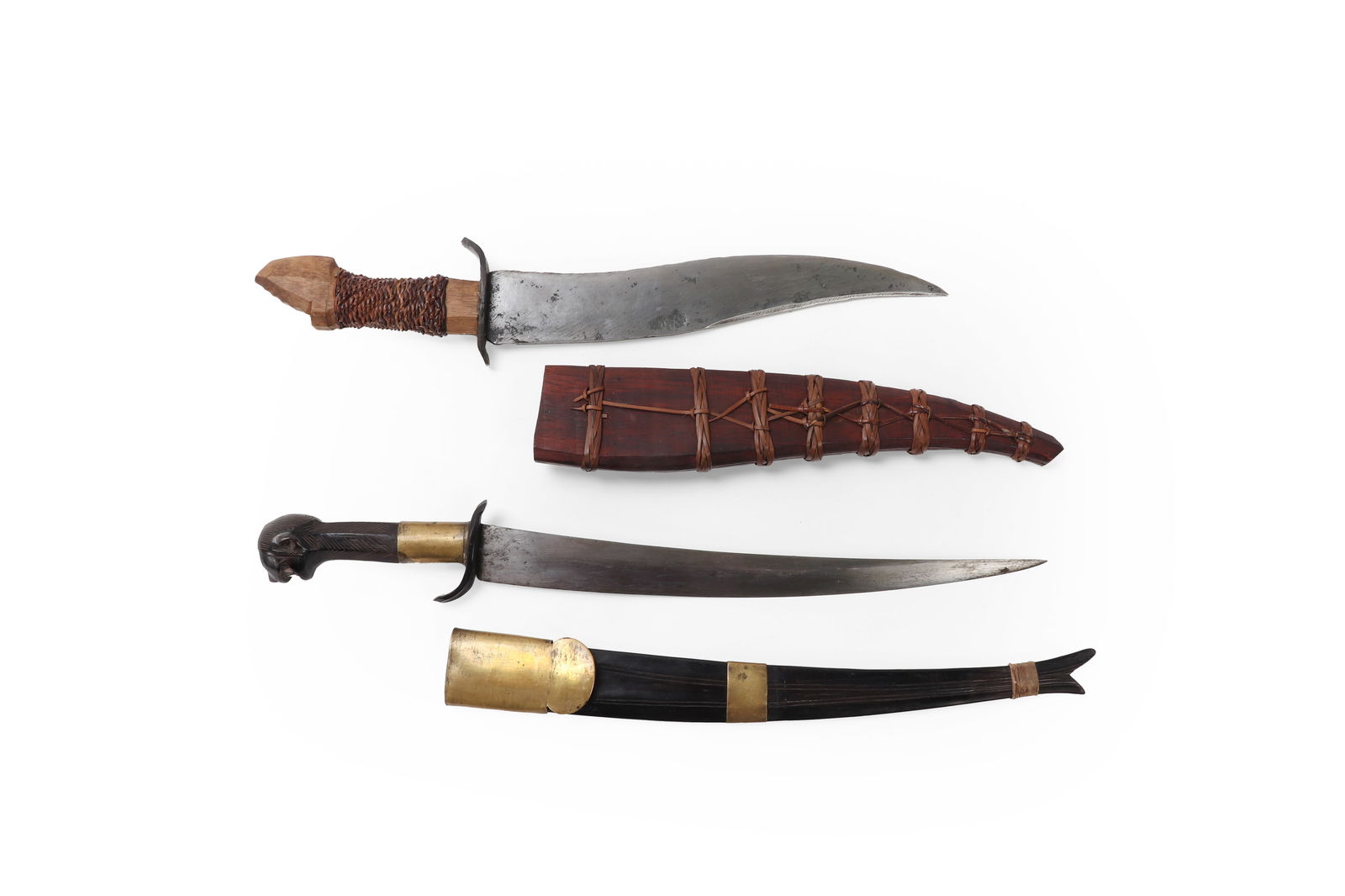 Two Fine Daggers & Scabbards: Attractive Philippines Carabao horn and brass mounted Bicol Deity Dagger with inset Mother of pearl teeth. Scabbard in matching carabao horn with fine brass bands with hemp fiber rope to the base. Bol