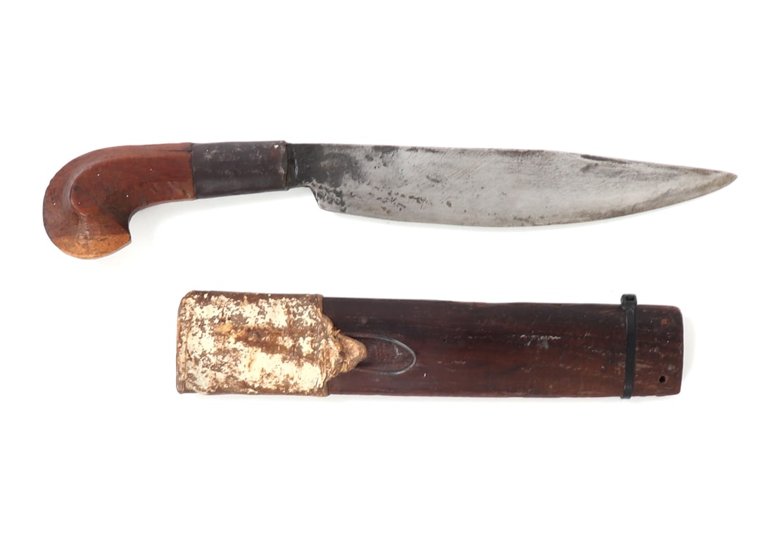 20th C. Visayan Plamingko Dagger w/ Scabbard: Circa 1900's Visayan plamenko dagger with leather and wood scabbard. Single edged curved blade leading to a metal collar and carved kakatua wood pommel. Size 15 1/2" L, blade 8 3/4" L
