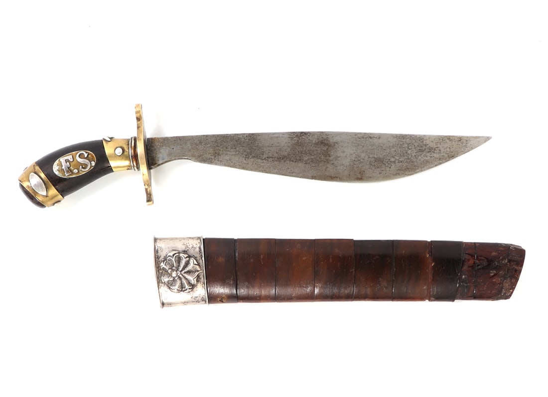 19th-20th C. Philippines Visayan Left Handed Tenegre Dagger: 19th. - 20th. century Visayan or Malay left handed Tenegre dagger with a "F.S." silver plated handle and gilt brass hardware. Banded wooden scabbard with silvered floral decorated cap. Brass crossguar
