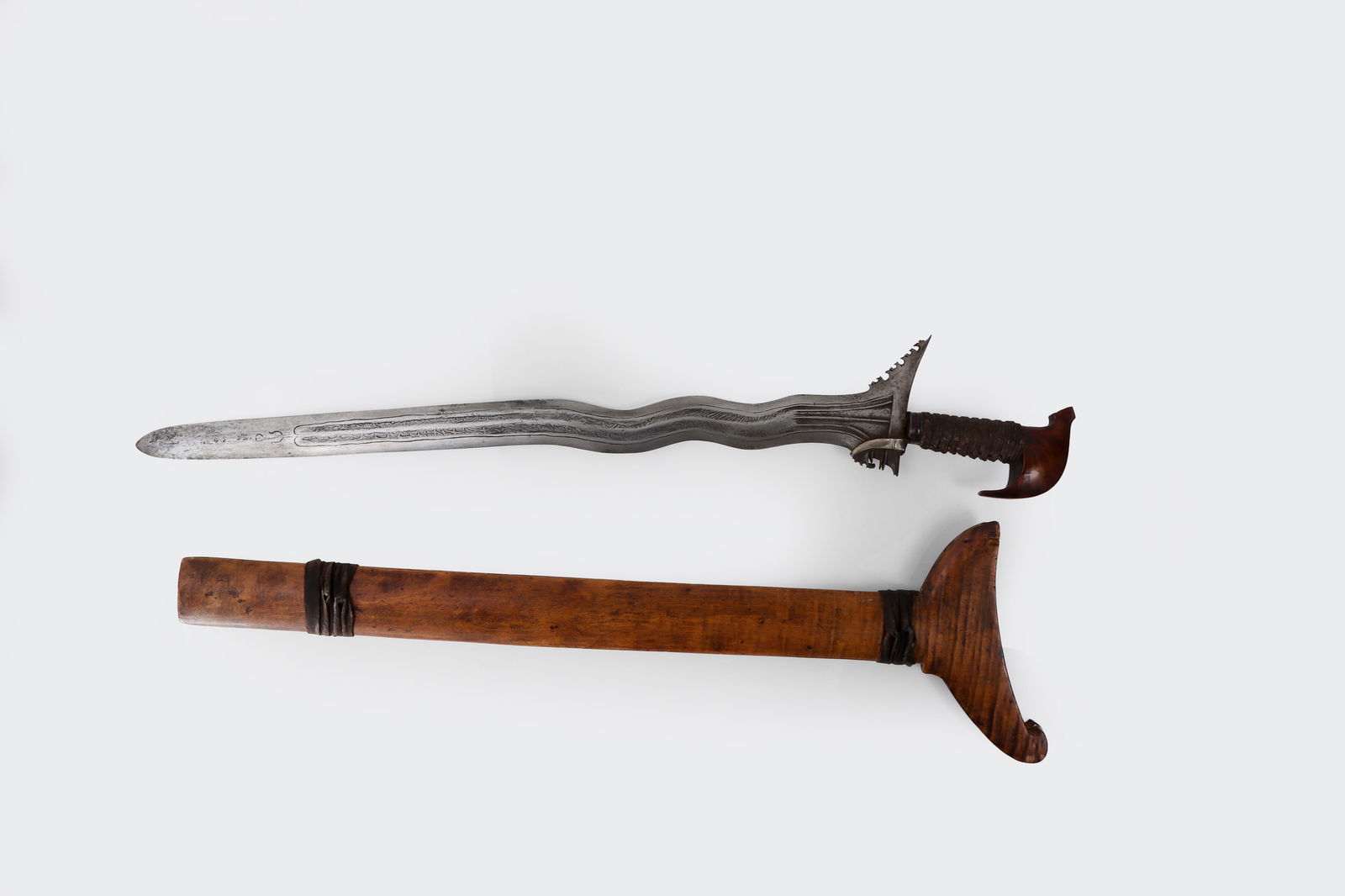 Excellent Rare Very Large Moro Kris Twistcore Double Fuller: Philippines, Moro Mindanao, 19th Century. Exceptional 5-wave highly prized traditional Filipino Kris sword. The blade is crafted using superior pamor. Watered pattern welded 5 wave, Kakatau pommel, fi