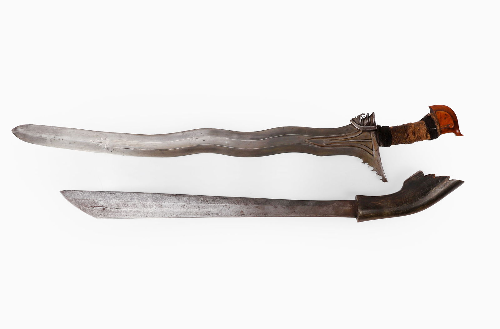 Excellent Moro Kris & Malay Twist core Sword: Excellent Moro Kris sword probably Visayan, Late 19th - Early 20th century. Double edge 5-wave blade inlaid in silver to a laminated steel etched blade. Hemp fiber cord wrapped grip with rare carved w