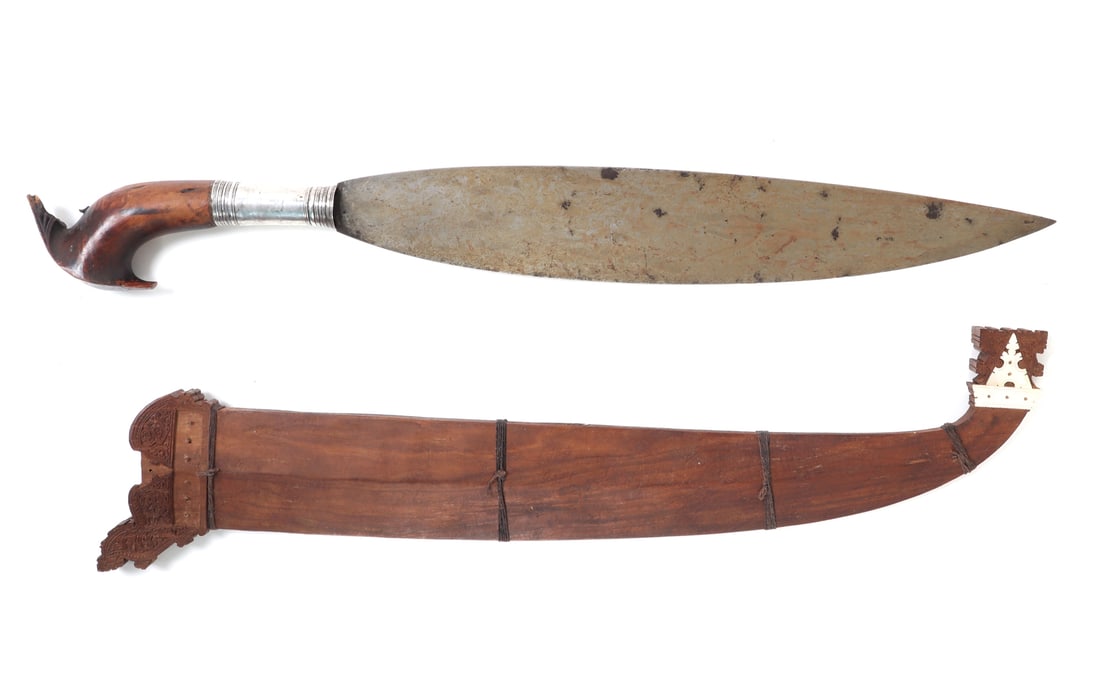 Moro Barong Sword & Scabbard: Philippines, Mindanao Moro Barong sword with scabbard, 19th century. Leaf shaped laminated steel blade with thick spine and a single edge terminating to a fine point. Bright polished silver sleeve to