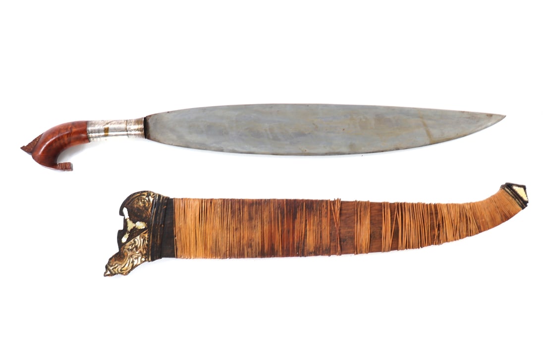 Moro Barong Short Sword & Scabbard: Philippines Moro Barong short sword and scabbard. Fine wide leaf shape form blade with single edge. Silver socketed sleeve to the base of grip and blade decorated with turned linear engraving. Exotic