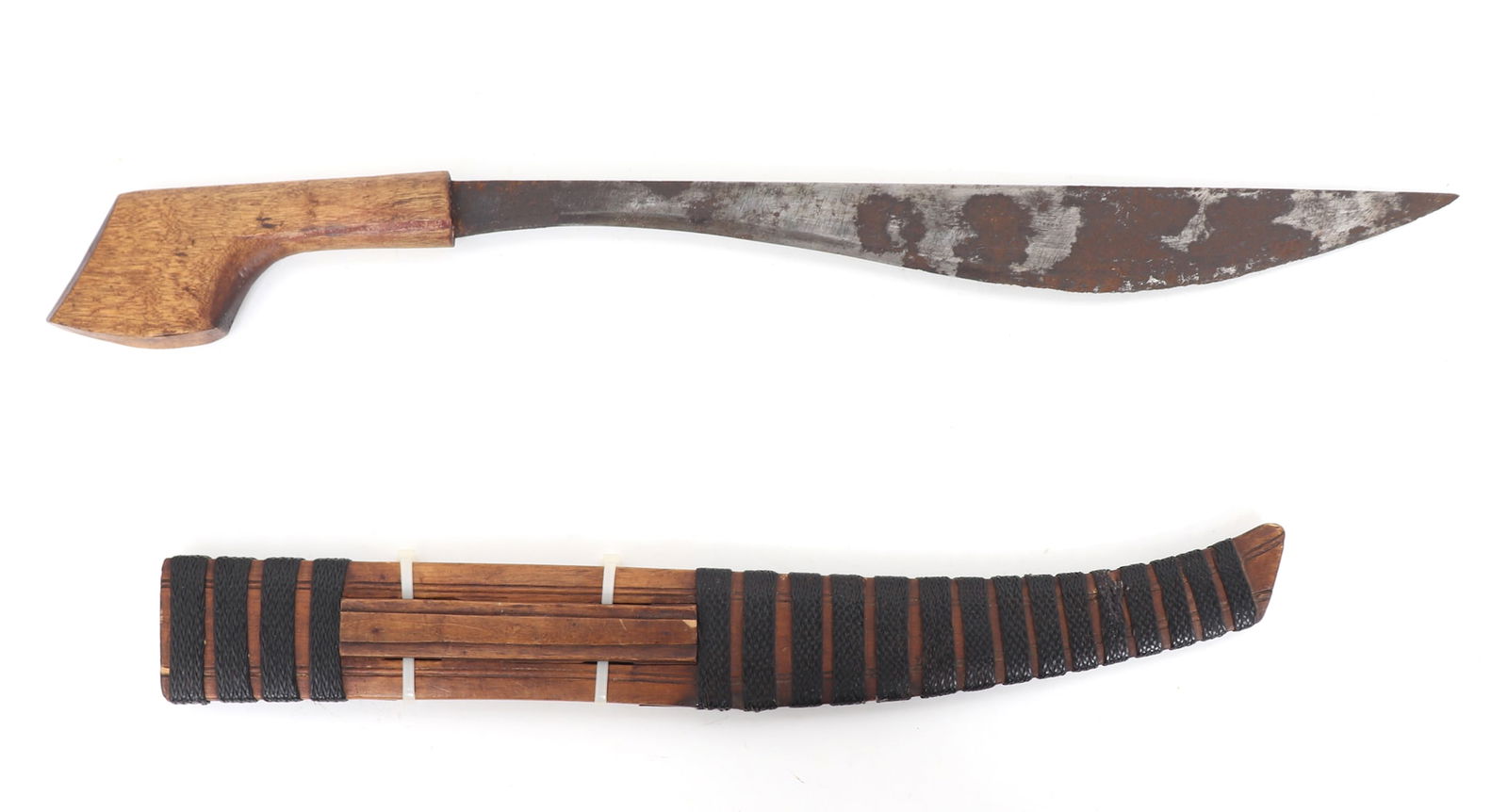 Philippines Lumad or Visayan Bolo Knife w/Scabbard: Philippines, Bolo knife with scabbard early 20th century or WWII-Era. Blade a wavy single edge with straight spine. Handle in a light brown wood with an inset fine grain cap to the pommel. Scabbard in