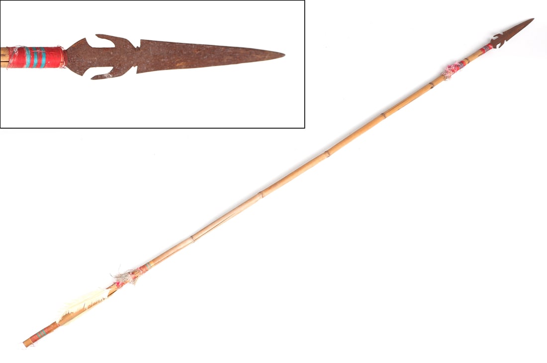 Rattan Philippines Ceremonial Spear: Filipino long ceremonial war spear. Hastate shaped barbed blade, leading to a decorated shaft with threads and feathers in colors ranging from red, turquoise, orange and white. Size 61" L, spear