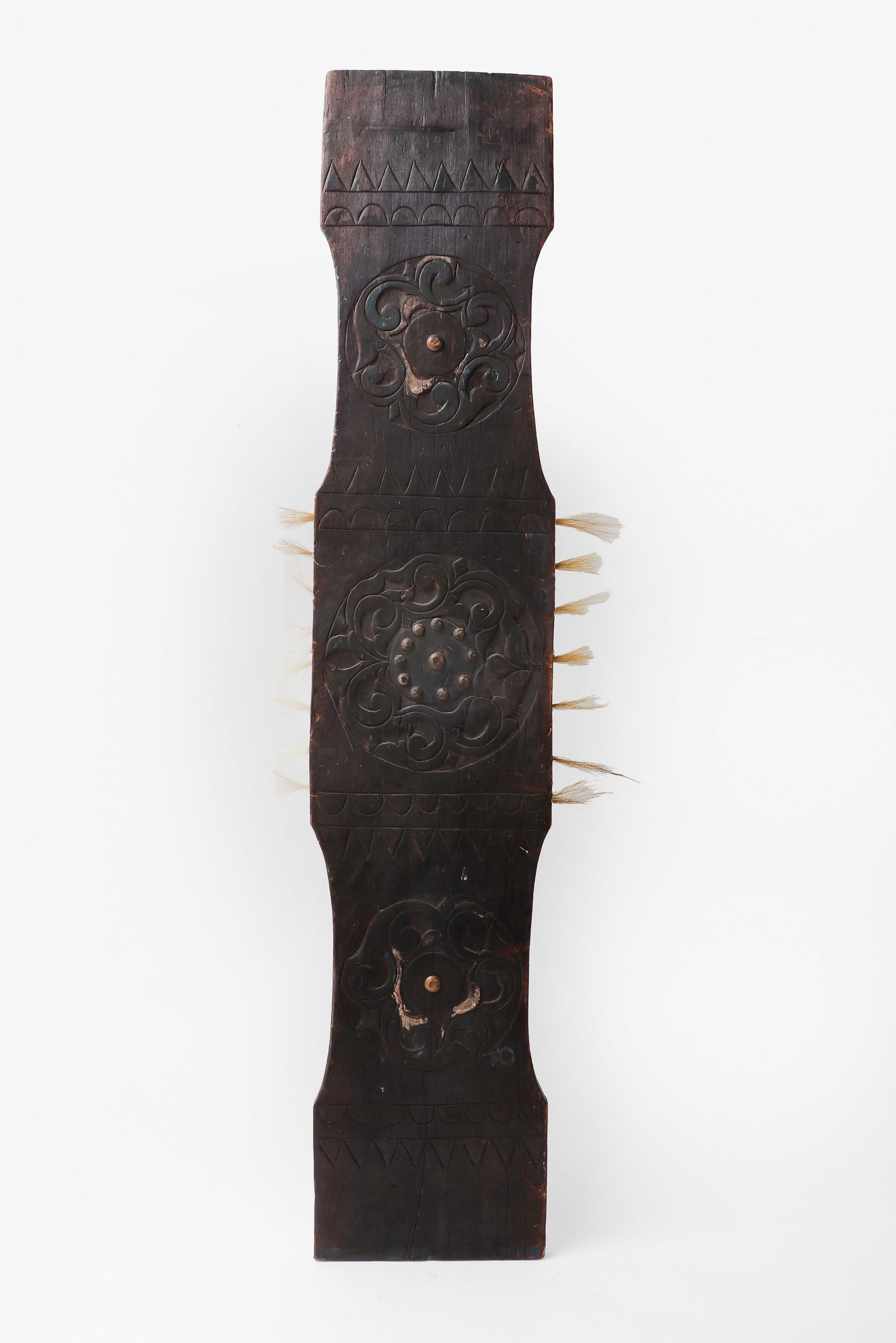 Lumad Horsehair Shield, 20th century: Philippines, Lumad, 20th century. Large example with remnants of red, white, and green polychrome with horsehair protruding at either side.