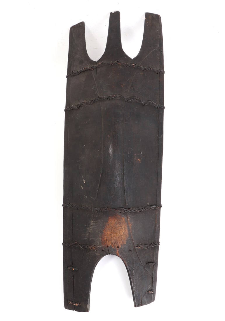 Philippines Kalinga Wood Shield, Ifugao Circa 1800s: Philippines Archipelagos, Ifugao or Bontoc tribes, Kalinga shield, late 19th century. Black painted with a worn spot to the center. Rattan wrapping in bands and sections to the top and bottom. Size