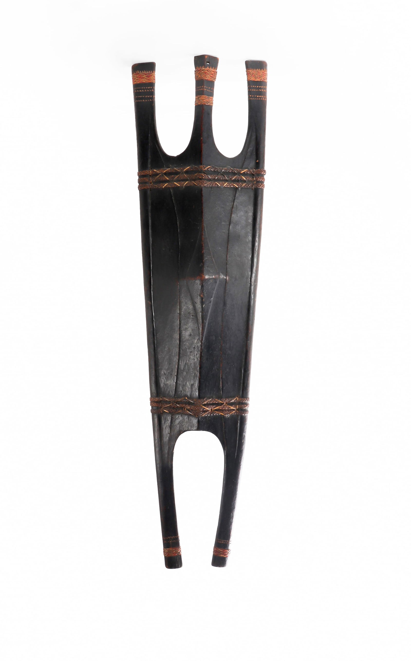 Authentic Bontoc Shield, 19th C.: Bontoc Shield with prongs and fine rattan interlaced wrappings. A distinctive 19th century, hand carved wooded shield from the Northern Luzon mountains in the Philippines. 46" x 11"Ex-Southern