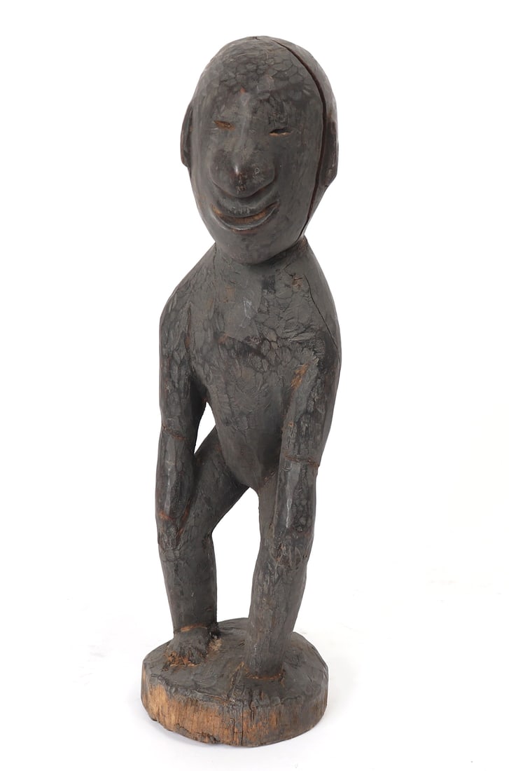 Unusual Ifugao Bulul Standing Statue: Unusual Philippines Bulul statue with uncharacteristically smiling face of a standing Bulul figure. The nose in an uncharacteristically wide form with small slanted eyes and notched all over with