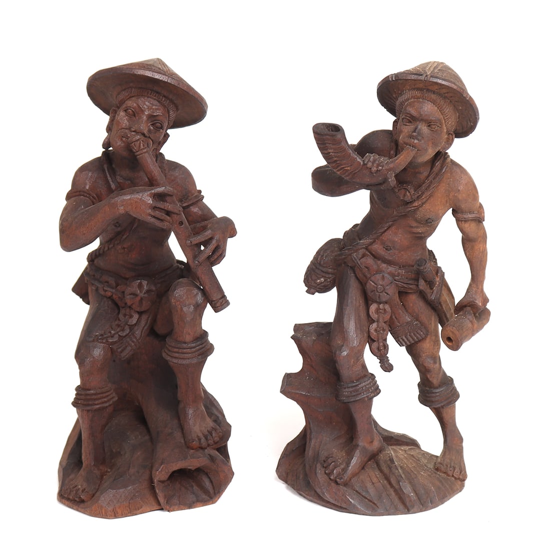 Ifugao Wood Carved Nativity Scene, Musicians: Late 20th century wood carvings of musicians for a Filipino nativity scene. On the left he joyously plays a flute while the right is on the trumpet with all the air in his lungs. Each wear