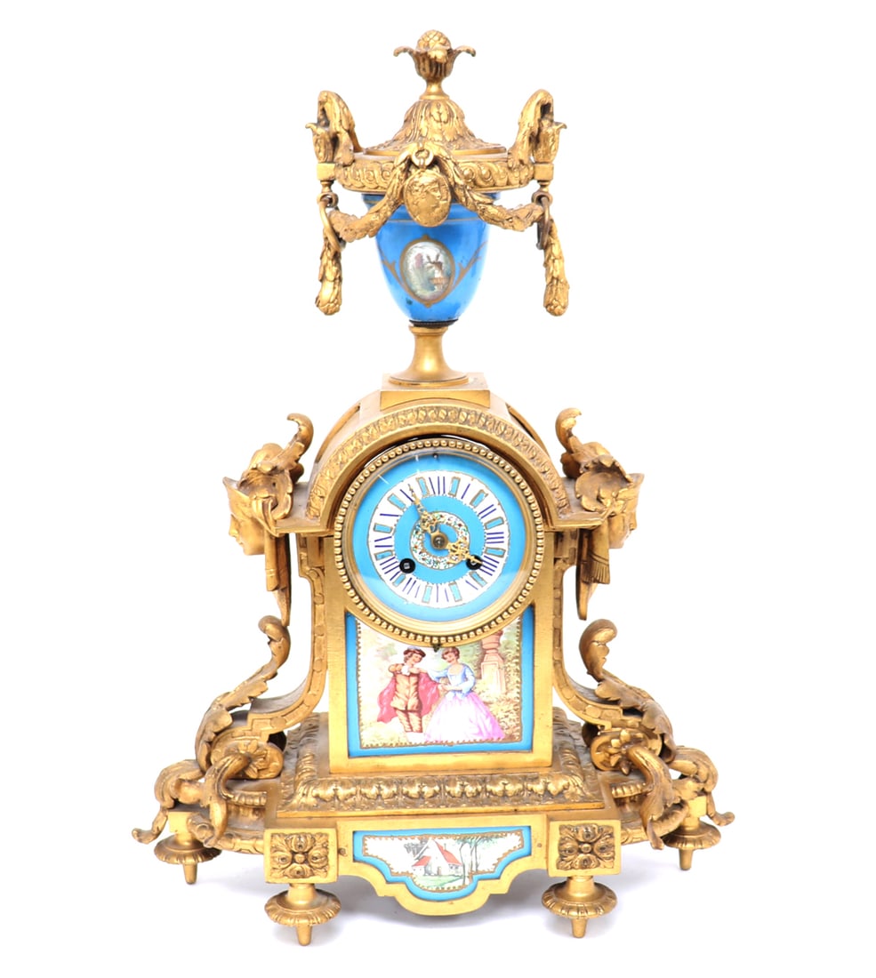 French Gilt Bronze & Porcelain Mantle Clock, Louis XVI-style: Fine and tall gilt bronze cased mantle clock with numerous inset panels of well painted porcelain. Case with broad leaf scrolling and two opposing faces at either side of the clock. Above a very ornat