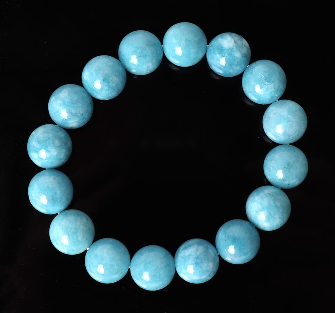 Attractive Aquamarine Beaded Bracelet: Genuine aquamarine beads strung in a lovely bracelet. Each bead with a lovely cloud like marbling throughout. More stunning in person. Size 7" L