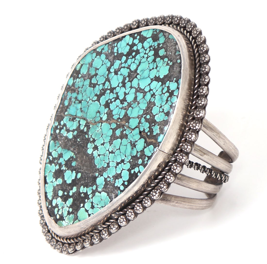 Rare Bisbee Turquoise Cuff Bracelet, Signed: Gorgeous and large section of Bisbee turquoise with incredible spider web weave throughout the stone. Dozens of applied silver flowers for the boarder. Four pronged cuff with added middle rope band