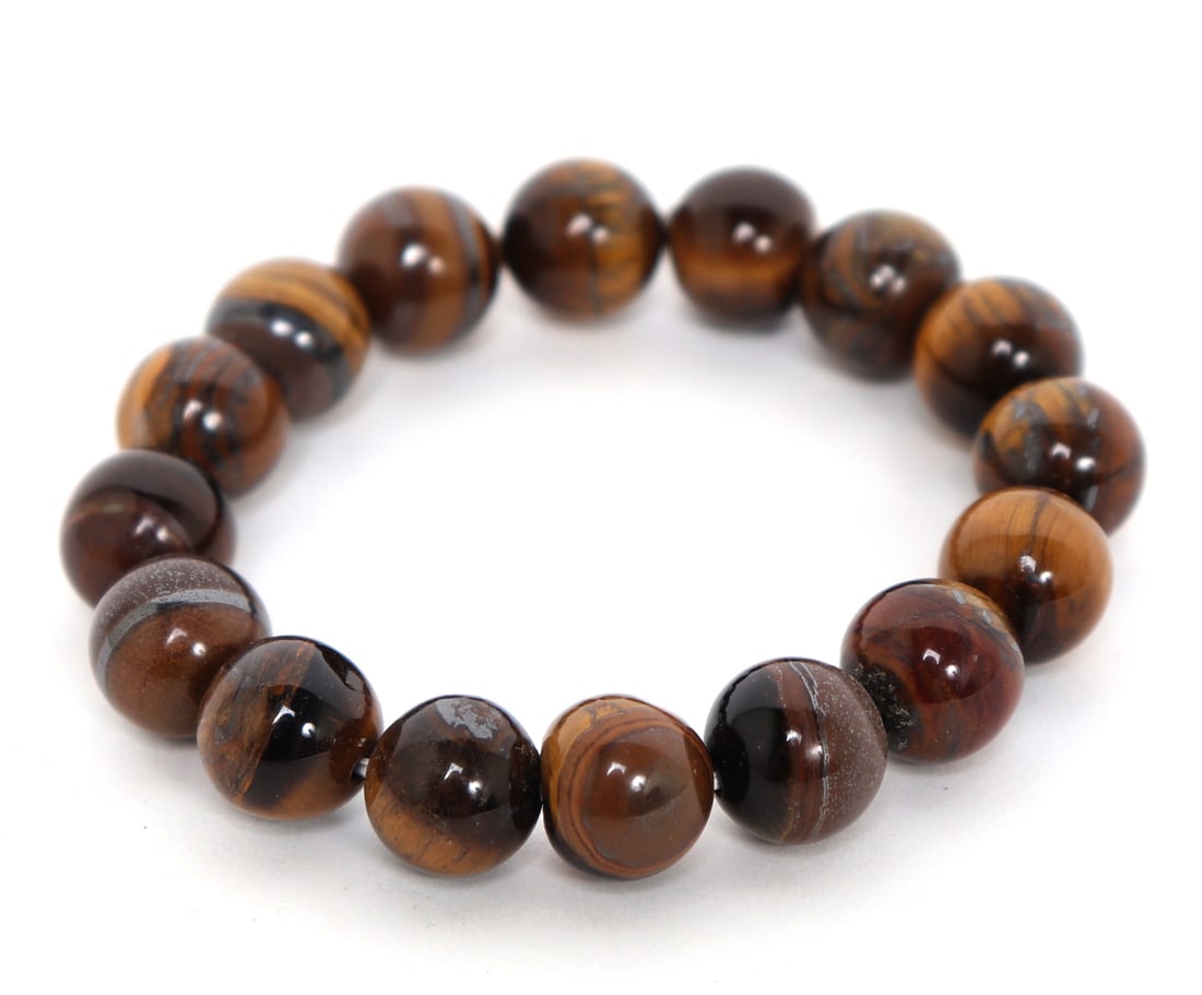 Stunning Tigers Eye Beaded Bracelet: Sixteen perfectly polished tigers eye beads, each with a unique eye, carmelized and gold bands throughout. Deep brown to bright shiny gold coloring with piercing tigers eyes throughout. Size 2 1/2" W