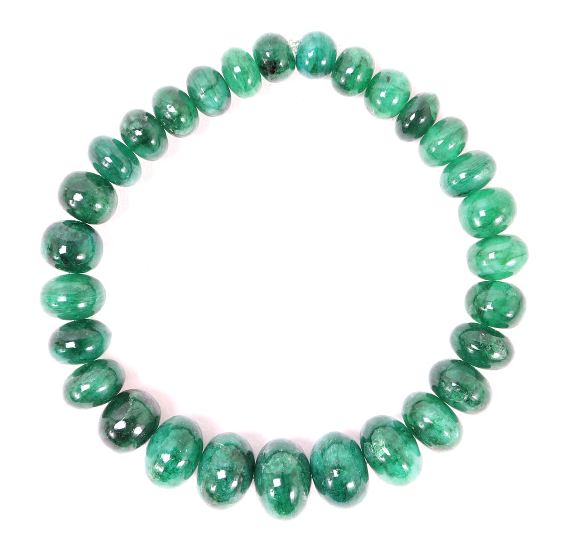 Beautiful Emerald Green Dyed Quartz Bracelet: Wonderful emerald green dyed quartz beaded bracelet with oblong shaped beads in a varied series of sizes from small to wide giving a crown like illusion. Size 2" W