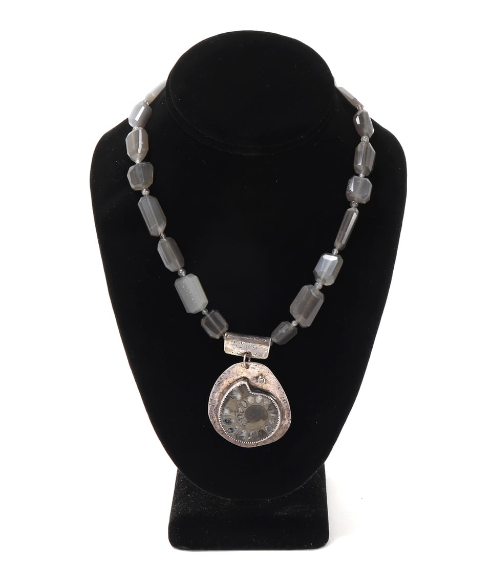 Beautiful Ammonite & Smoky Quartz Necklace: Lovely hand made necklace with brilliant smoky quartz drilled beads, ammonite mounted in silver setting. Signed by the artist, Jennifer Katz and marked 'Eternal Growth' to the reverse. Size 15" L,