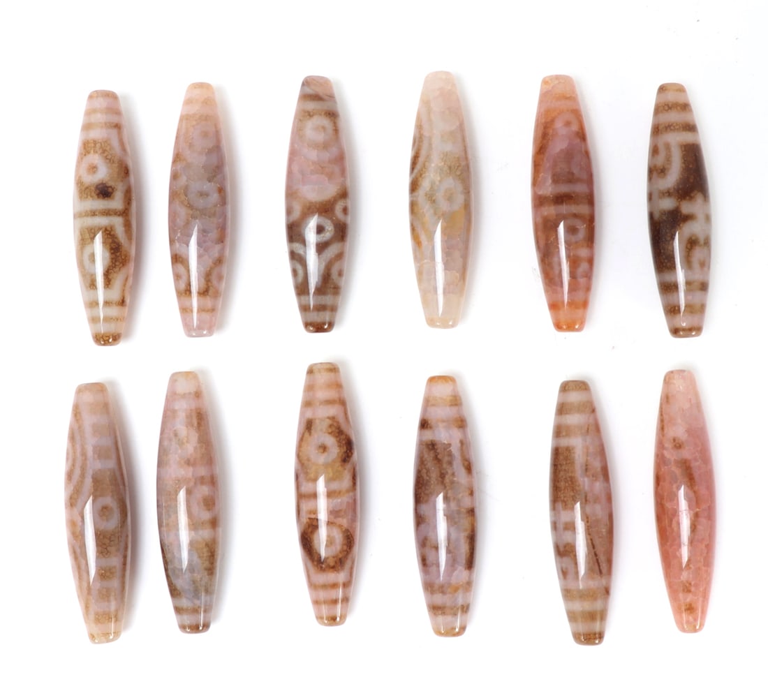 12 Gorgeous Tibetan Dzi Beads: Wonderful collection of Tibetan dzi beads in various hues including coral pink, cream white, chocolate brown and more. Each bead includes beautiful white banding and 'eye's throughout. Size 2 1/4" L