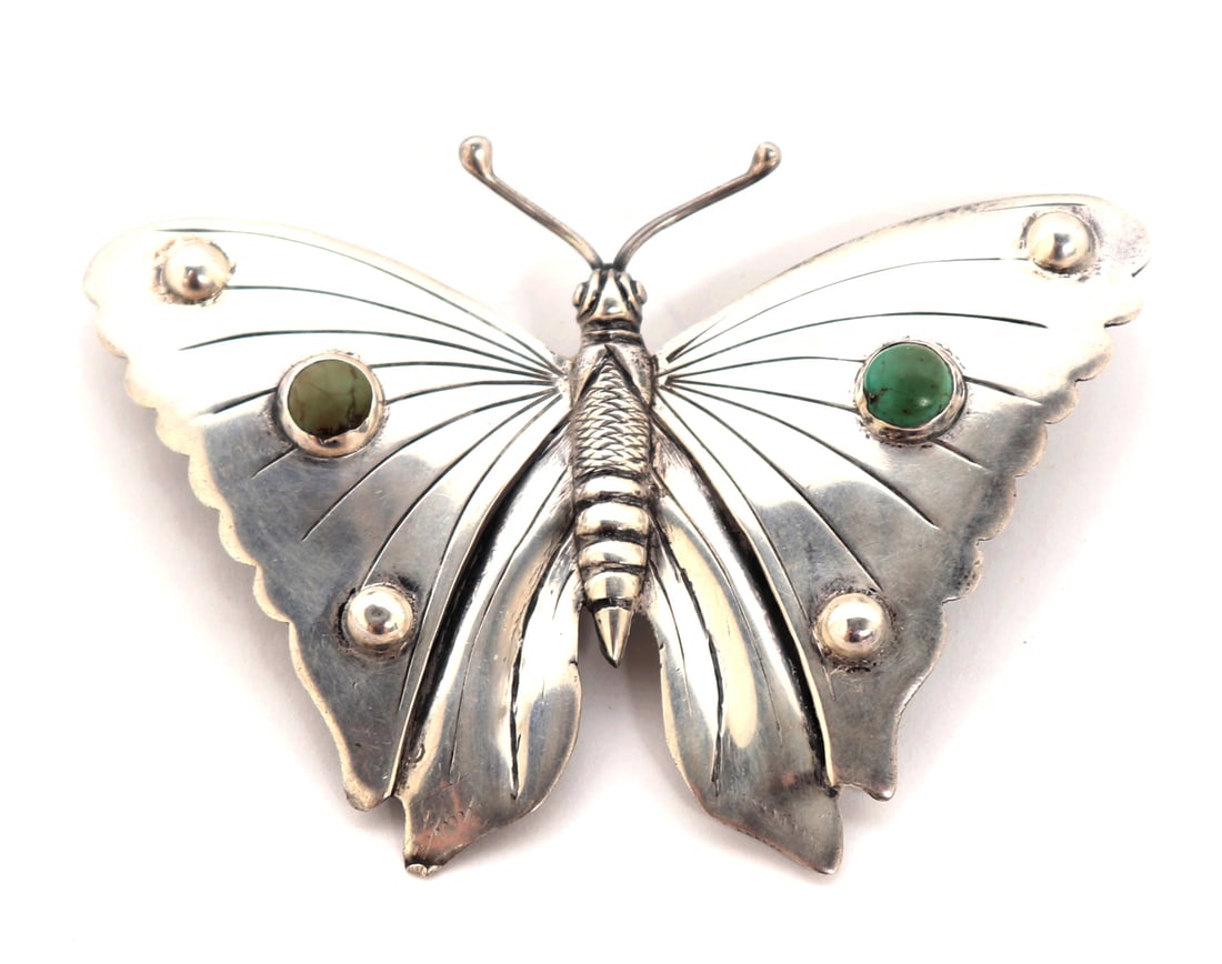 Lovely Navajo Sterling Silver & Turquoise Butterfly Pin: Finely hand crafted sterling silver butterfly with two turquoise inlayed beads to each wing. Body wonderfully crafted with long antennae, bulbous eyes, and striped wings. Underside marked Mexico.