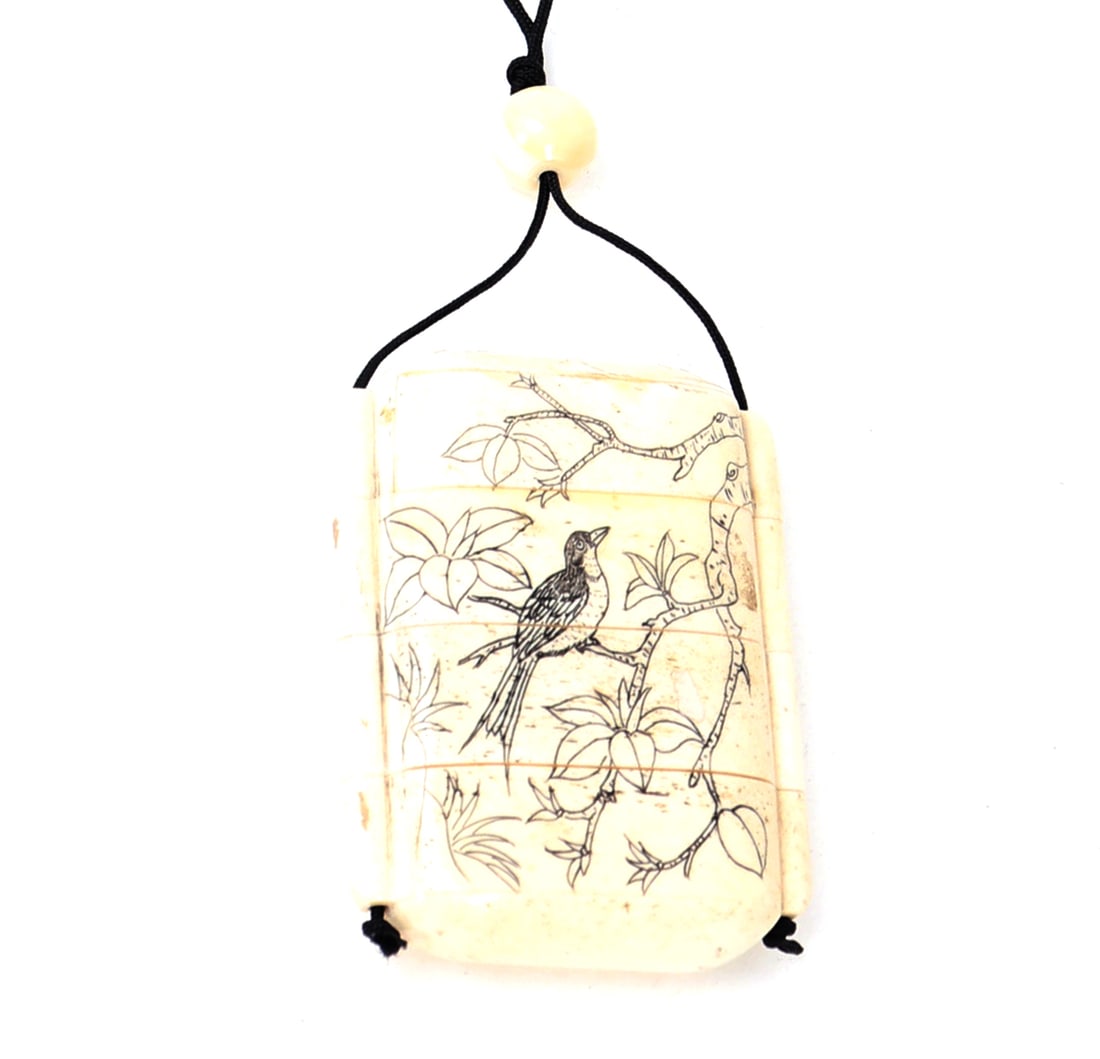 Japanese Four Panel Hand Carved Inro: Finely carved Japanese bone carved four panel inro with a bird perched in a blossoming tree to one side, and an erotic scene between lovers on the other. Four panels are secured by a cord and bauble. 