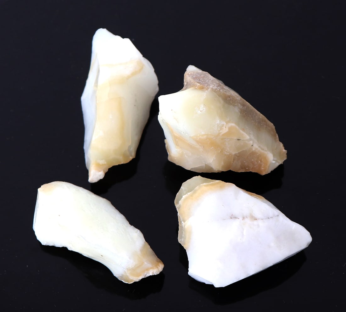 Four Pieces of Common Opal: Lovely sections of common opal with iridescence and caramel coloring throughout. Size of largest piece 1 1/2" L
