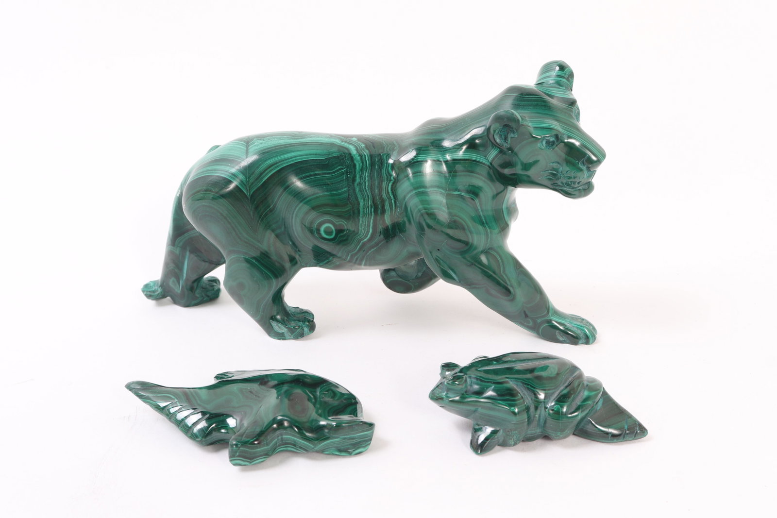 Fine Trio of Malachite Carved Animals: Group of three malachite carved animals including a tiger our cougar, fish and a crouching frog. Each piece is beautifully naturally marbled with light to dark green ripples throughout. Size 6 3/4" L