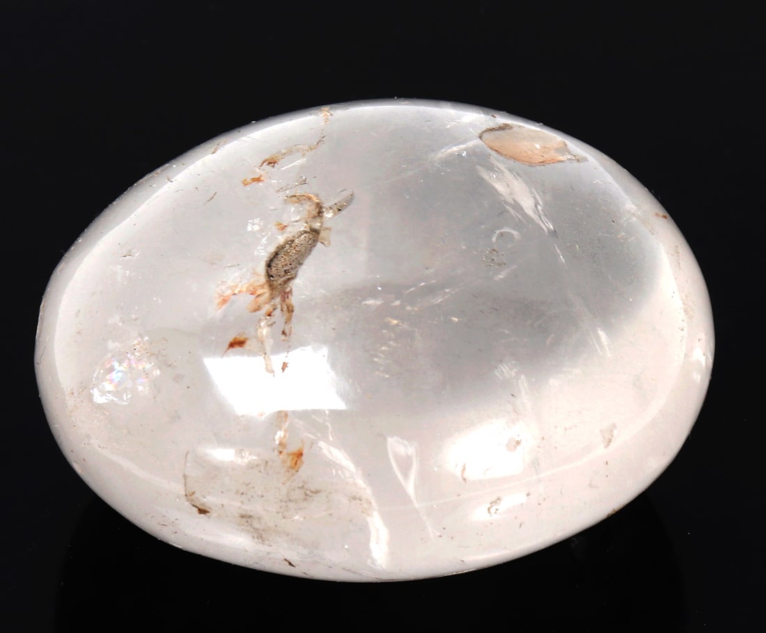 Heavy Rock Crystal Quartz Mineral Specimen: Wonderfully preserved and polished rock crystal quartz mineral specimen with natural earthen inclusions throughout with incredible translucency when held to natural light. Size 2 1/2" W x 2" H,