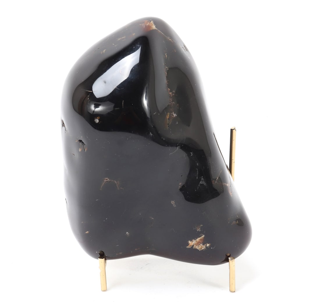 Wonderful Raw Amber Section on Stand: Raw amber large nugget showcasing a rich golden-brown hue with areas of lighter translucence and natural inclusions. Size 6 3/8" L, 6 3/4" H on stand, Weight 702 g without stand