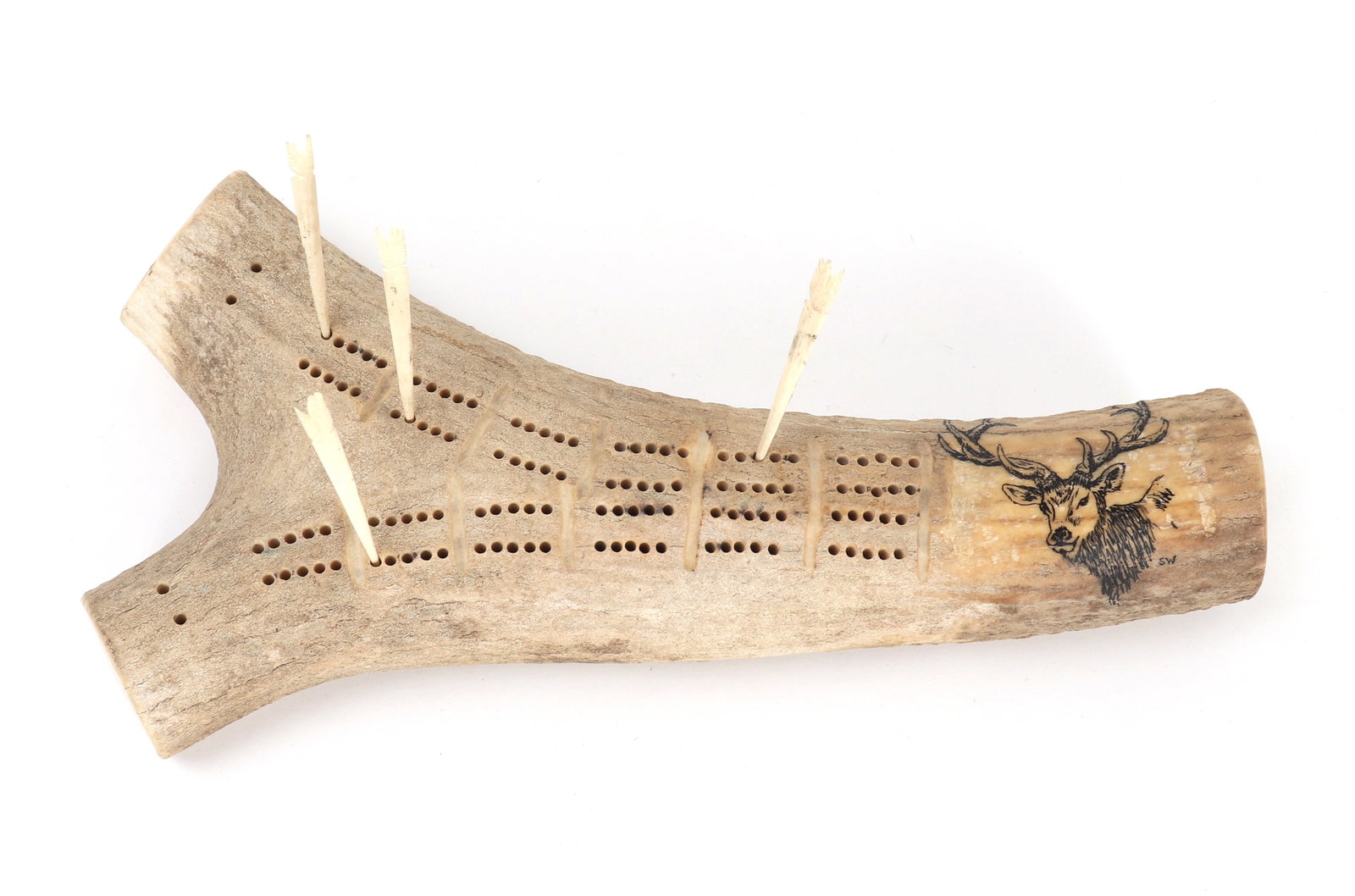 Handsome Elk Antler Carved Scrimshaw Cribbage Board: Well carved elk antler scrimshaw cribbage board with an elk wood burnt into on the face of the antler. Pierced throughout with two starting points on the left hand side. Four remaining playing pegs