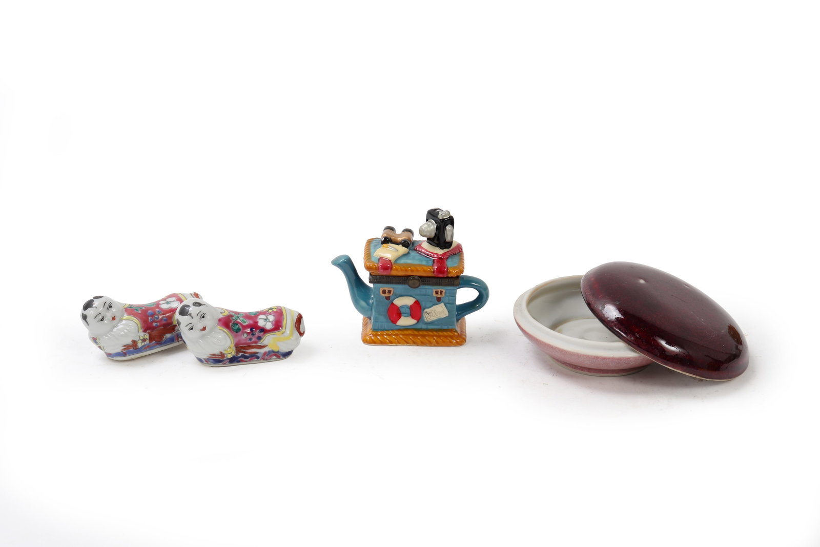 Assorted Lot of Small Porcelain Miniatures: Left most a Pair of Figurines, two colorful porcelain figurines depicting serene figures in vibrant attire, displaying intricate floral patterns. Teapot Ornament: A whimsical blue teapot featuring a