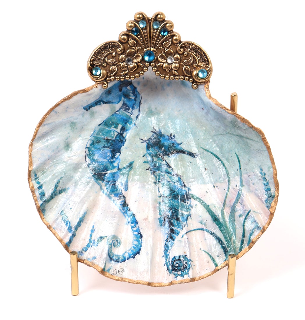 Lovely Painted and Gold Framed Sea Shell w/Stand: Beautifully painted to the inside with a pair of deep ocean blue colored sea horses among kelp forests. Framed in gold, with an applied metal and gem plaque. Would make for a lovely addition to any