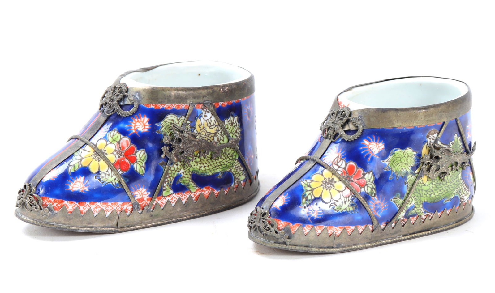 Chinese Silver Mounted Lotus Shoe Pair: Beautiful hand painted Chinese porcelain lotus shoes with fine pierced openwork and strand silver mounts over the surface. Four character seal mark to the interior. Old Hallmark no worn to the undersi