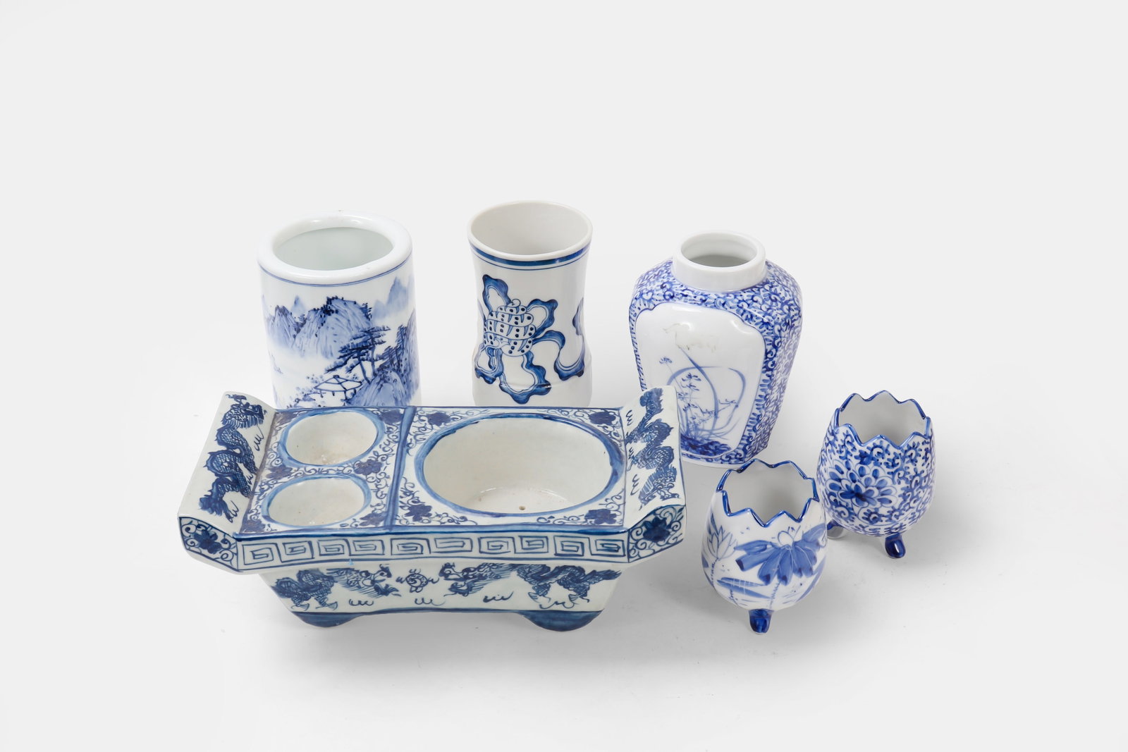 Collection of Blue & White Porcelain: Chinese porcelain set includes six pieces showcasing intricate designs. Featuring traditional motifs of mountain landscapes, floral patterns, and symbolic imagery, each piece is crafted with delicate