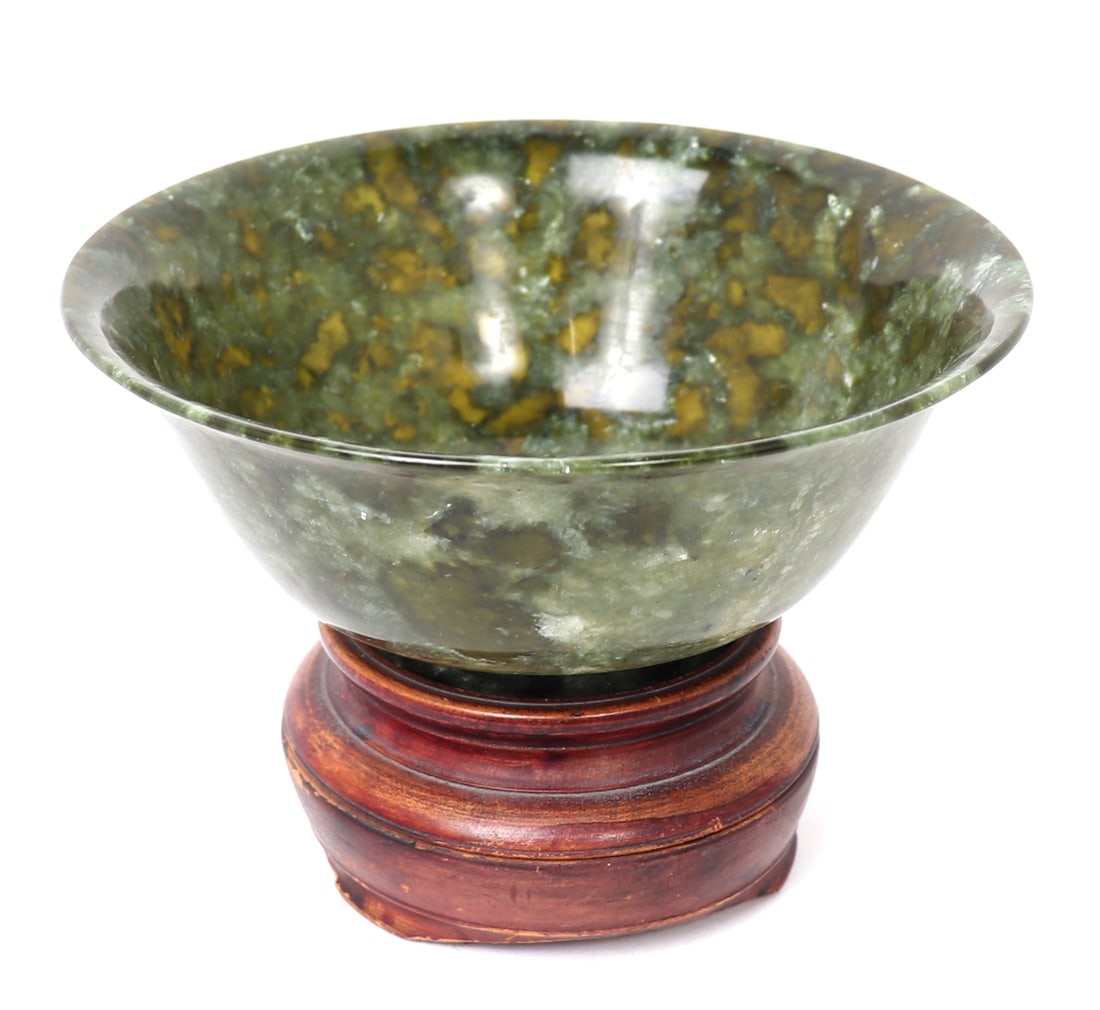 Lovely Chinese Spinach Jade Bowl with Stand: Chinese spinach jade carved bowl in a lovely petite form, with several translucent sections throughout. Deep green to light spinach green coloring throughout. Wonderful custom wood carved stand. Size