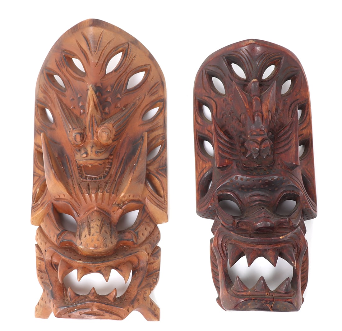 Lot of Two Vintage Hand Carved Filipino Dragon Masks: Two wood hand carved vintage dragon masks from the Philippines. Each mask with doubled dragons, large sharp teeth, protruding horns from the upper dragons and pierce work throughout. Size of largest 1