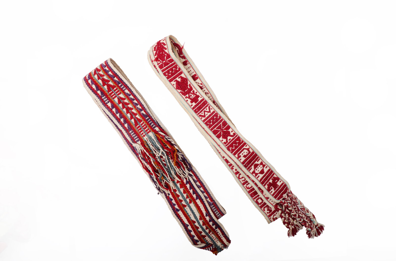 Two Handwoven Navajo Wool Sash Belts: American Southwest, Navajo, 20th century. Pair of handwoven wool sash belts, each of elongated rectangular form. One belt features a polychrome linear design composed of alternating bands in red, crea