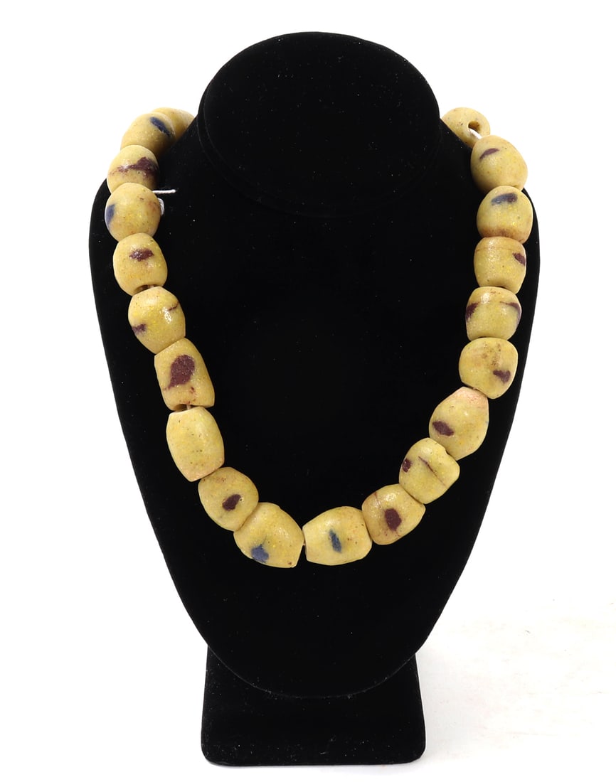 Yellow Krobo Powder Glass Trade Bead Necklace: West Africa, Ghana, Krobo Glass Trade Bead Necklace, 20th century Composed of a strand of large, irregularly formed powder-glass beads in a warm ochre-yellow ground, each decorated with scattered