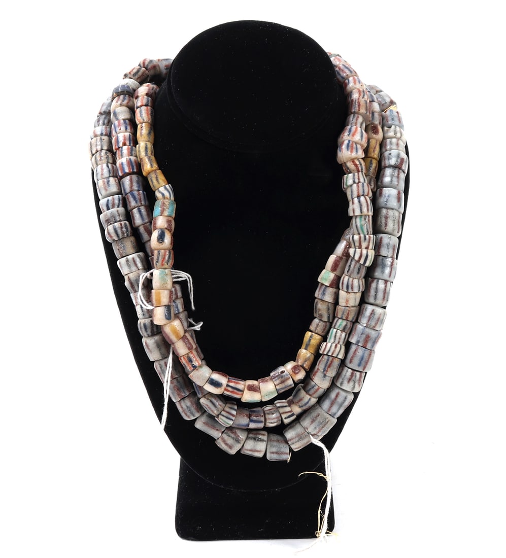 Three Strands of Hand Crafted African Trade Beads: 20th Centrury Africa. Beautiful brightly colored hand crafted African trade beads. Each uniquely shaped and colored throughout including orange, red, turquoise, blue and more. Size 26" L, bead 1/2" W