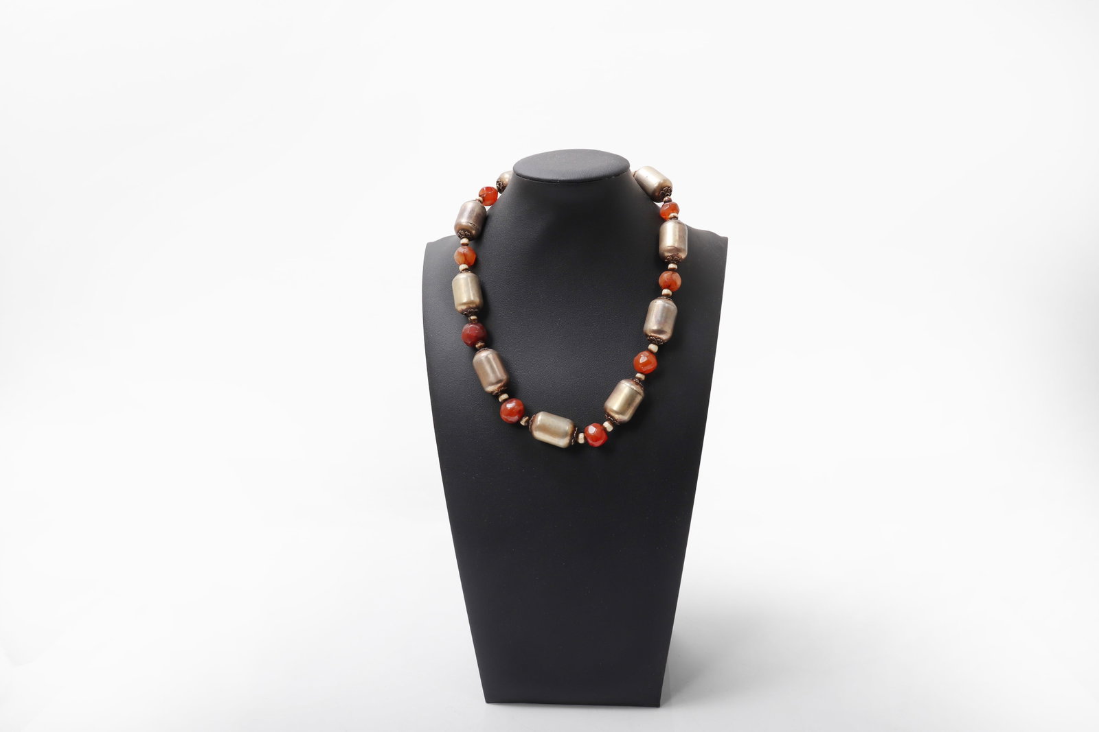 Sri Lankan Kandy Necklace with Carnelian Beads: Sri Lanka, Kandy region, probably 18th?19th century. Necklace composed of large barrel-form metal beads interspersed with carnelian beads, the bold arrangement creating a strong and elegant rhythm